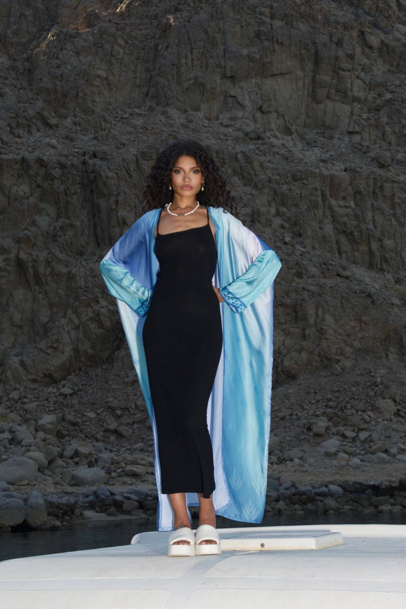 Elevate your style with the Indigo Dream Ombré Abaya Set, featuring a flowing blue gradient design over a sleek black dress, perfect for summer chic.