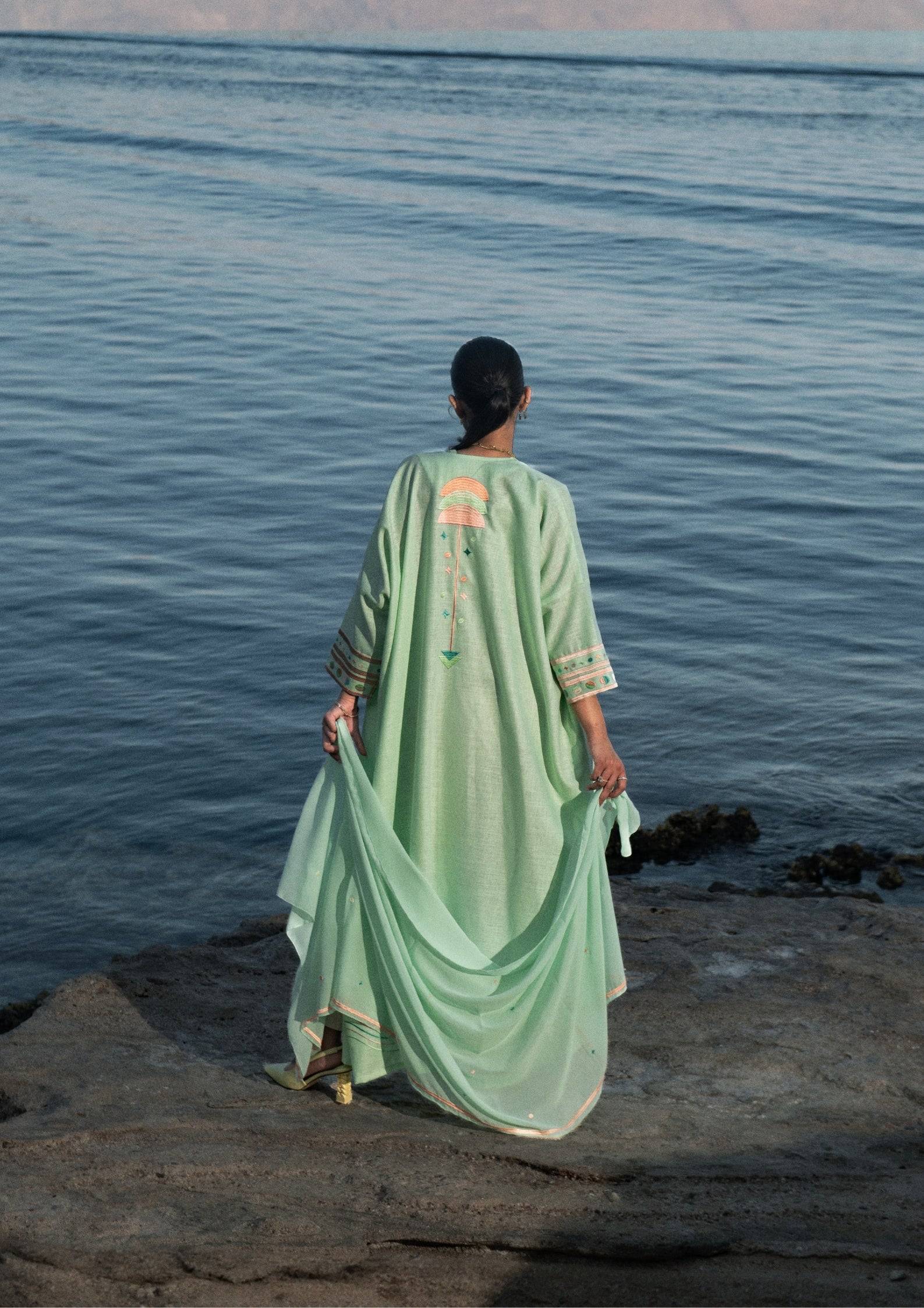 Flowy Birthday Abaya & Scarf Set in cold mint by the sea, showcasing breezy elegance and embroidered back design.