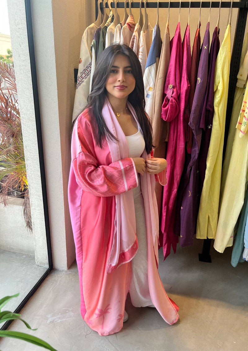 Barbie-Inspired Pink Abaya Set displayed in a boutique, styled with a white inner outfit for a fresh, modern traditional look.
