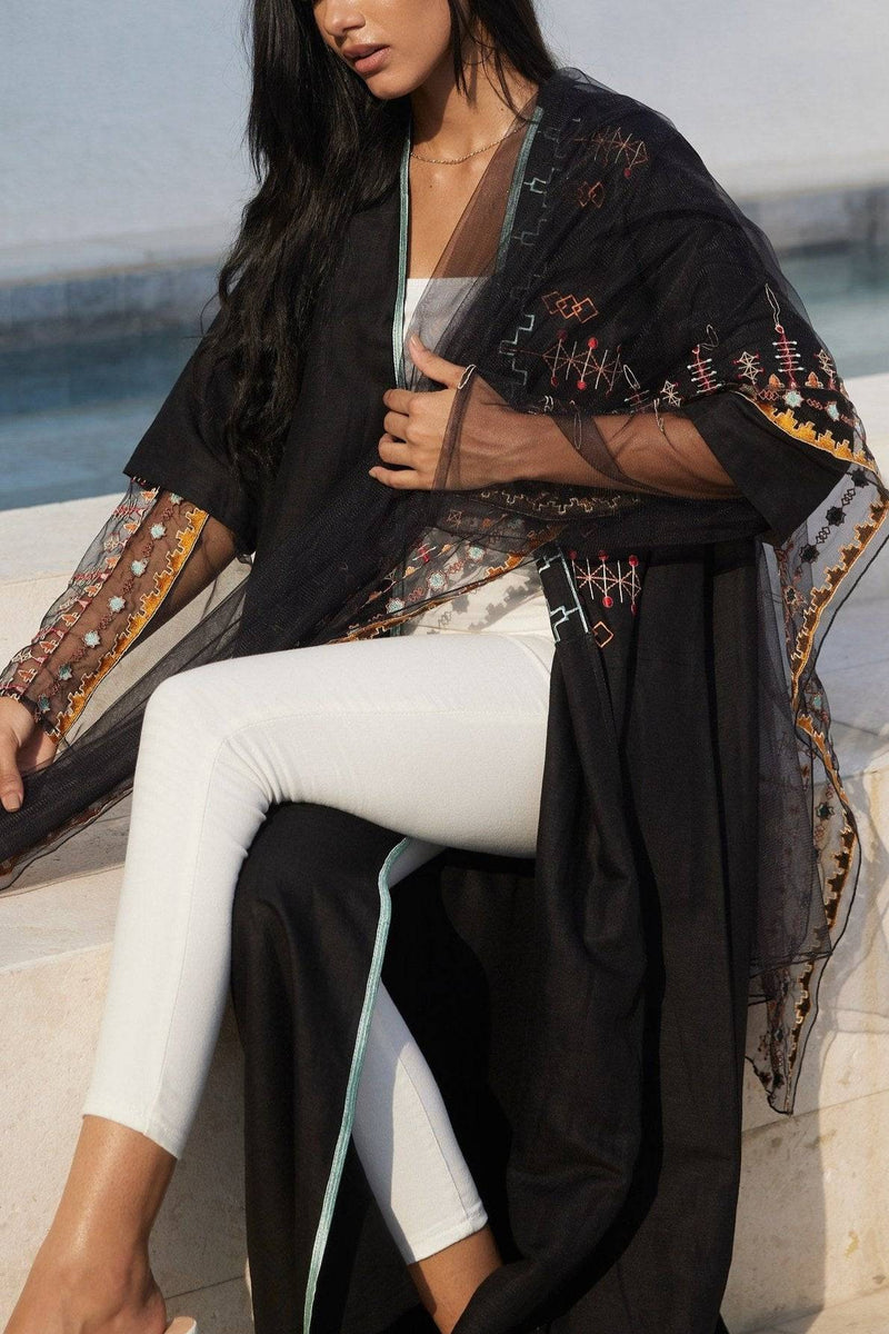 Saudi Abaya & Scarf Set styled with white pants, showcasing embroidered details and versatile traditional fashion appeal.