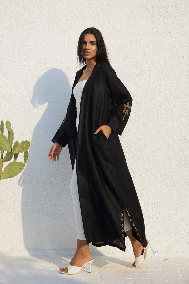Side view of Nakhla Hoodie Abaya with embroidered sleeves and side slit accents. Designed in breathable organic linen.