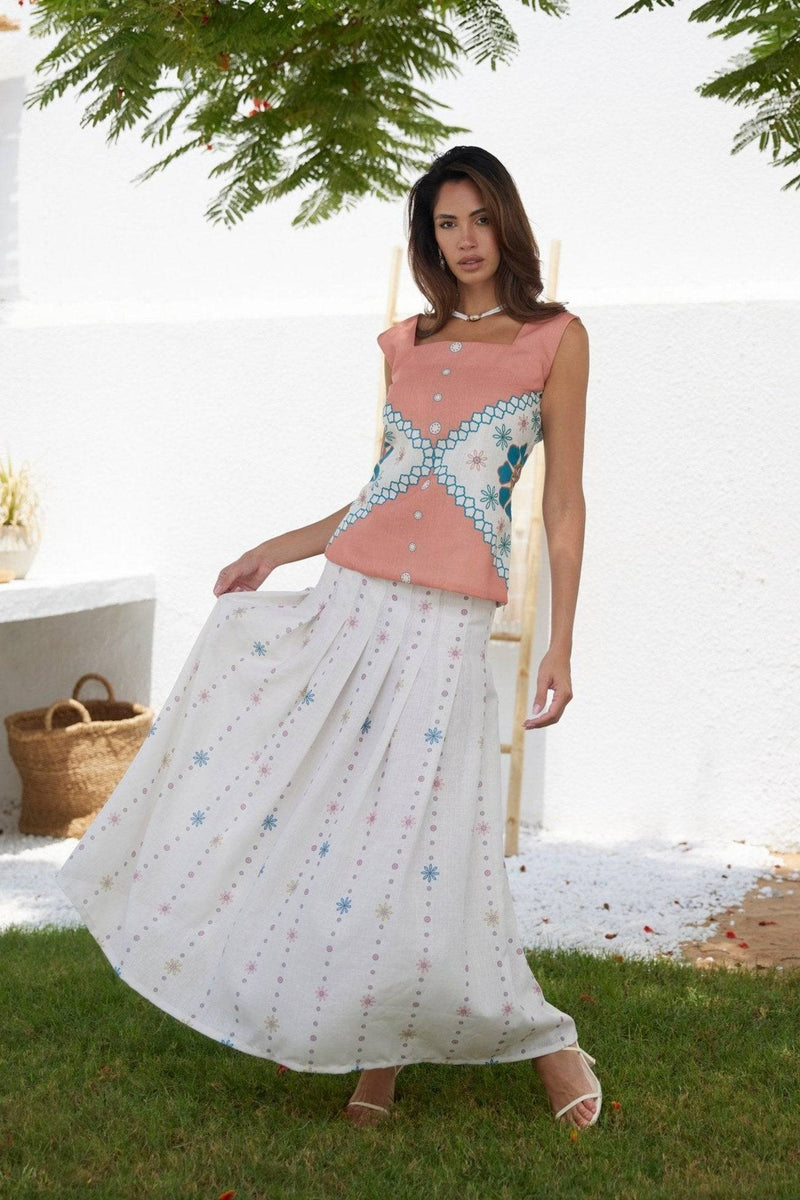 The Amara Top - Mexican Design Patterns | Modern Silhouette styled outdoors with a white embroidered skirt for a resort-ready look.
