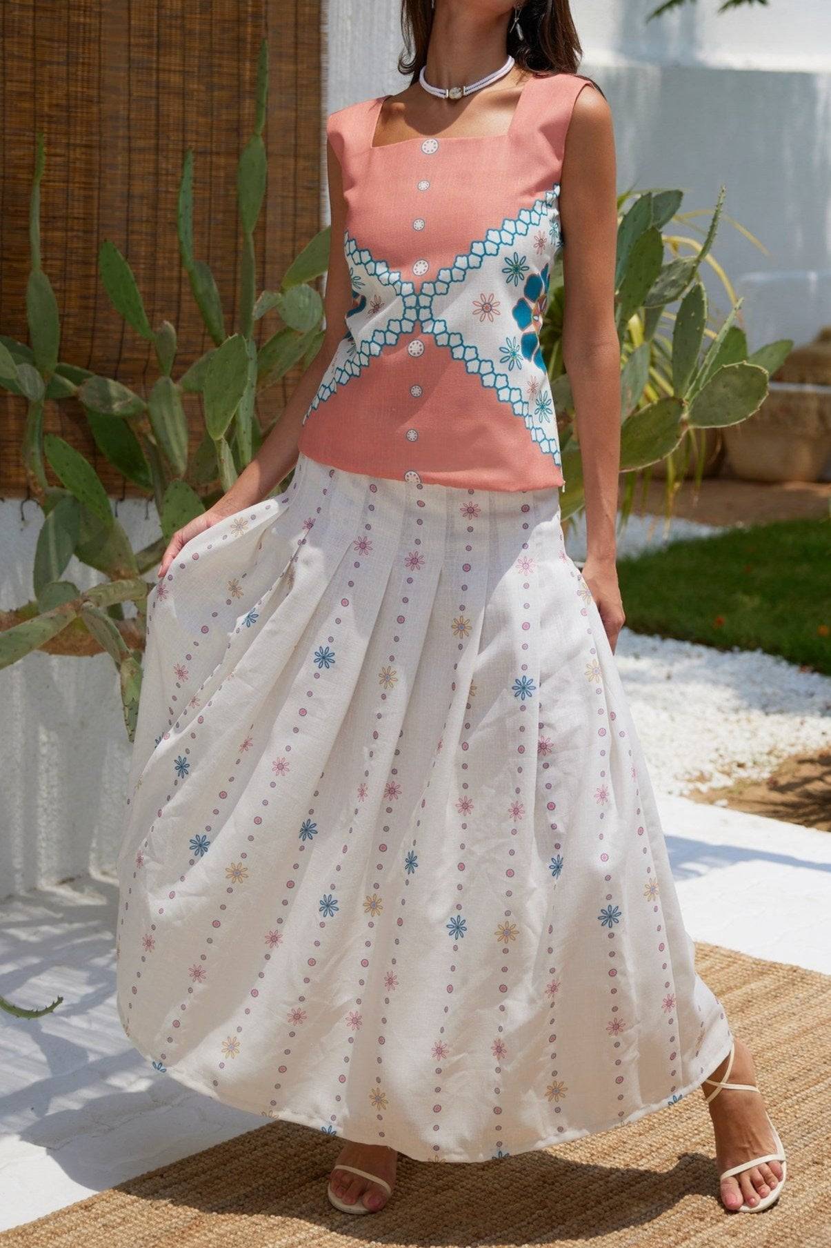 The Amara Top - Mexican Design Patterns | Modern Silhouette in coral with blue floral accents, styled for a breezy summer day.