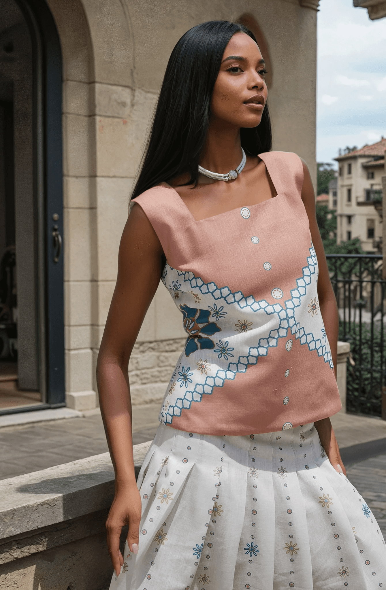 The Amara Top - Mexican Design Patterns | Modern Silhouette in soft pink with geometric embroidery, styled with a white flowy skirt.