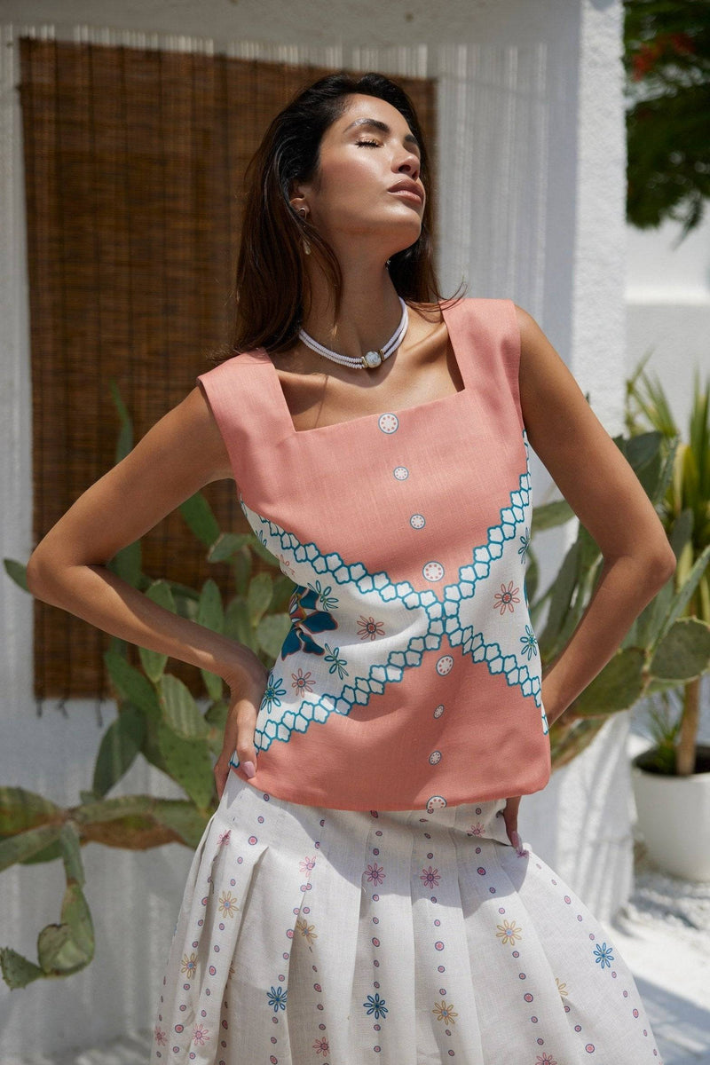 The Amara Top - Mexican Design Patterns | Modern Silhouette in coral pink with blue and white accents, styled for a summer look.