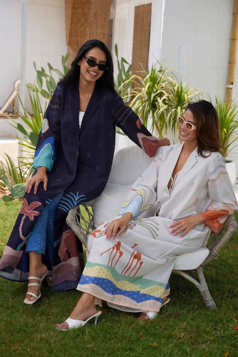 Smiling models in The Jeddah Horizon - Abaya & Scarf Set, showcasing contrasting colorways and artistic sleeve designs.