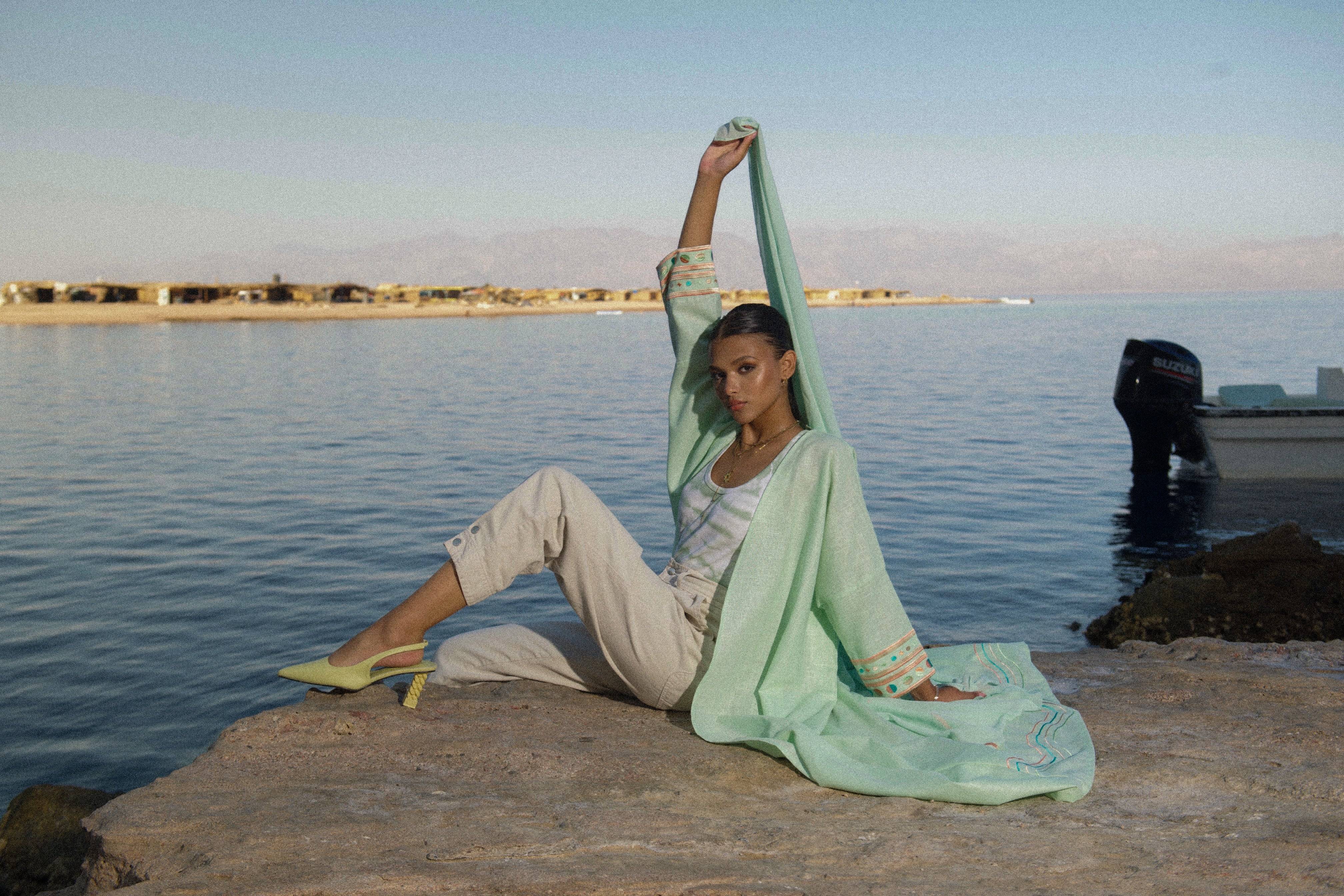Model poses in Birthday Abaya & Scarf Set in cold mint, styled with casual pants and heels for a modern traditional look.