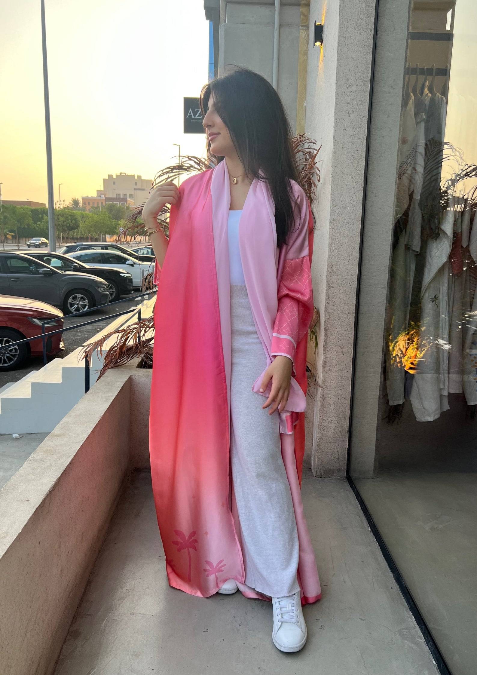 Barbie-Inspired Pink Abaya Set worn outdoors at sunset, styled with white casual wear for a versatile day-to-night outfit.
