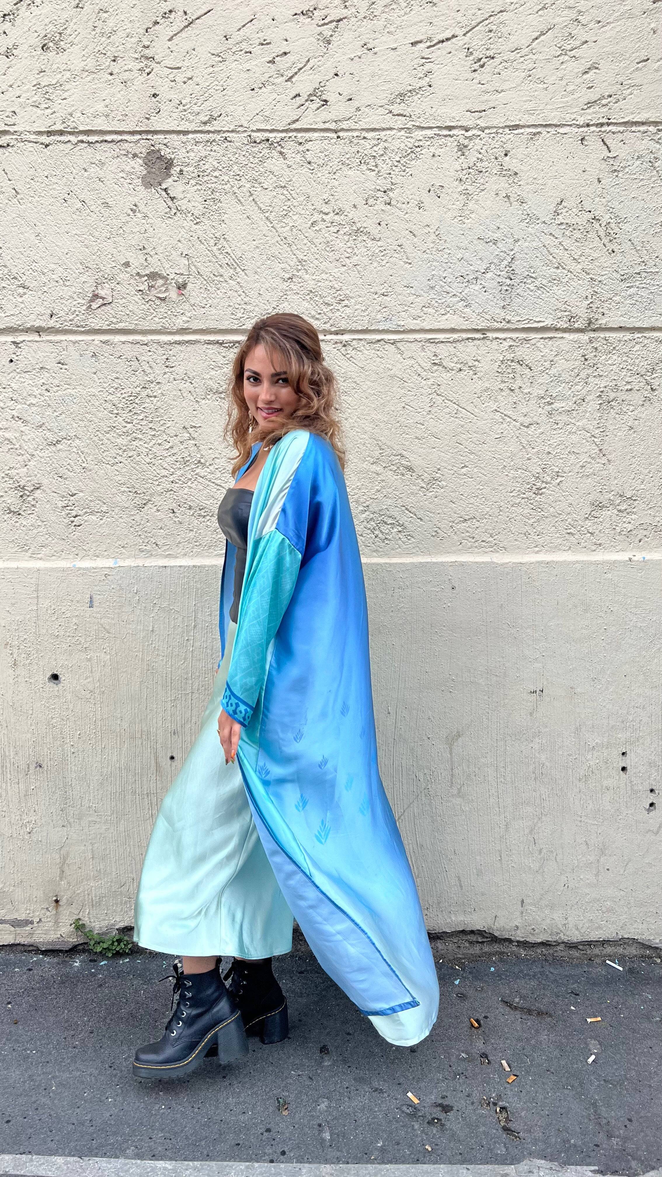 Indigo Dream Ombré Abaya Set paired with a mint dress and boots, showcasing its vibrant ombré tones and lightweight fabric for urban summer style.