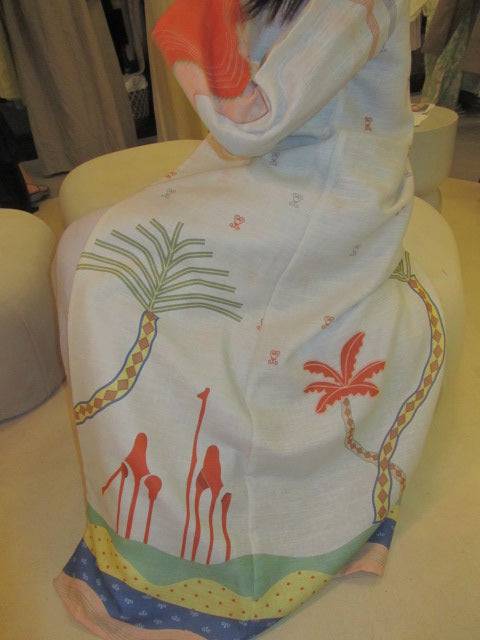 Side view of The Jeddah Horizon - Abaya & Scarf Set, showing detailed hemline and sleeve artwork in soft lighting.