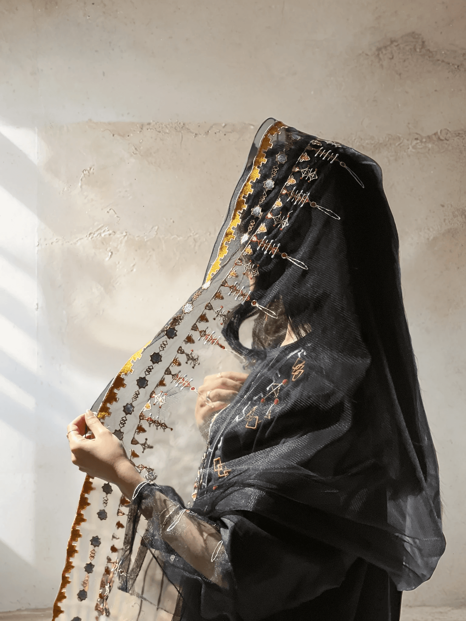 Close-up of Saudi Abaya Scarf with gold and copper embroidery, highlighting the heritage-inspired craftsmanship and sheer fabric.