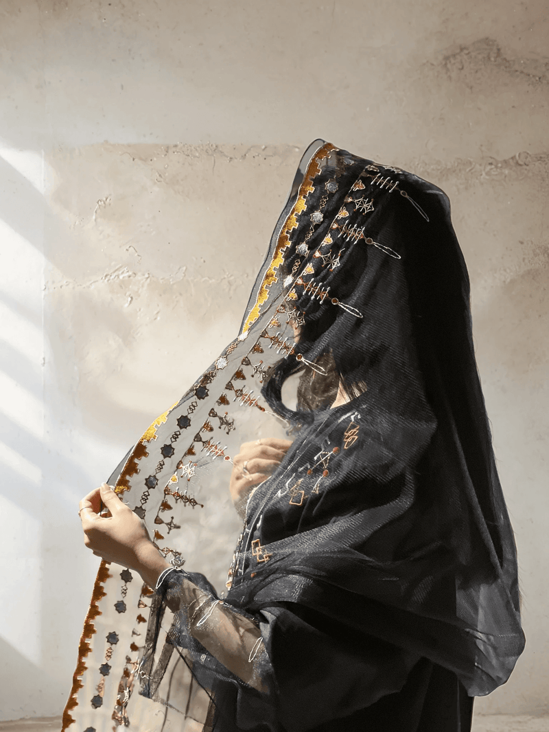 Close-up of Saudi Abaya Scarf with gold and copper embroidery, highlighting the heritage-inspired craftsmanship and sheer fabric.