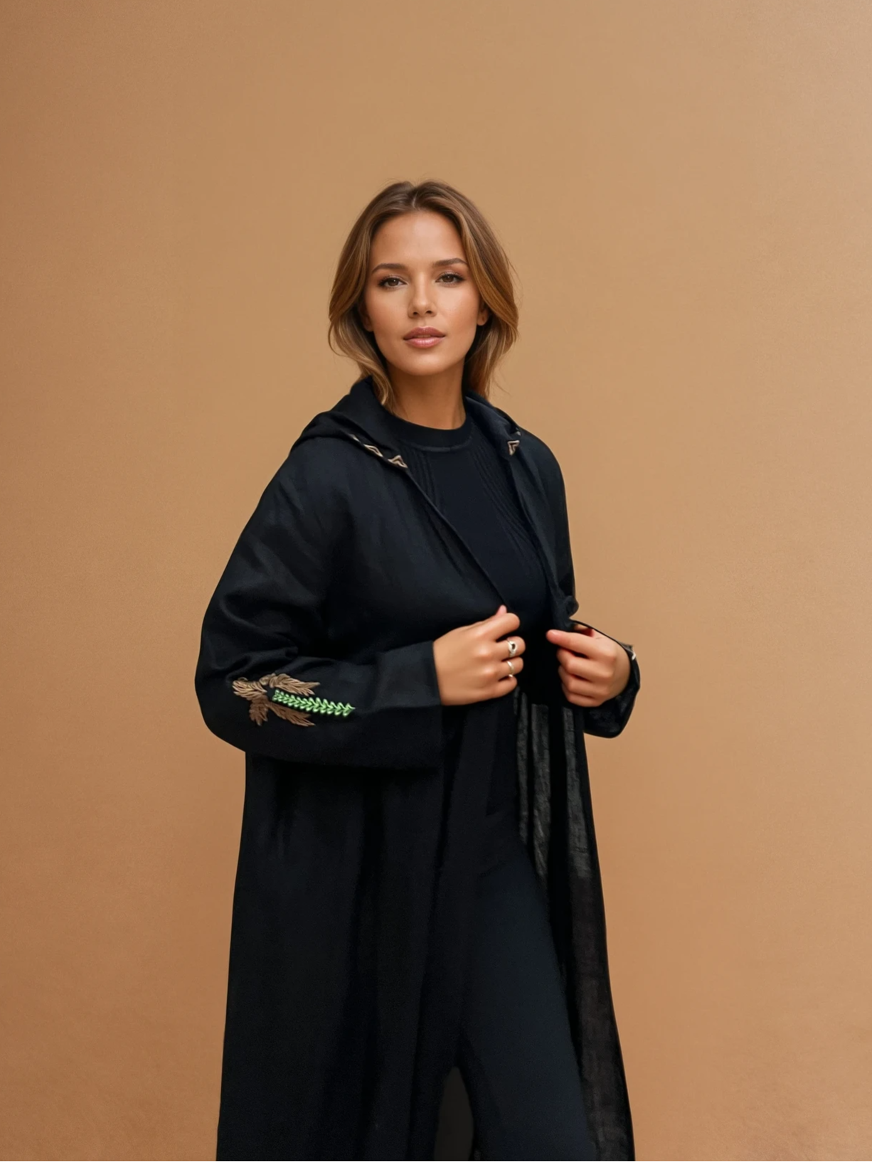 Elegant Nakhla Hoodie Abaya with hood and palm tree embroidery, made from breathable organic linen. Ideal for modern traditional wear.