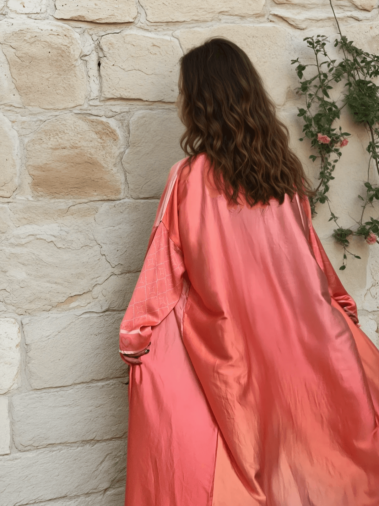 Back view of the Barbie-Inspired Pink Abaya Set highlighting its glossy fabric and relaxed silhouette, ideal for ceremonial occasions.