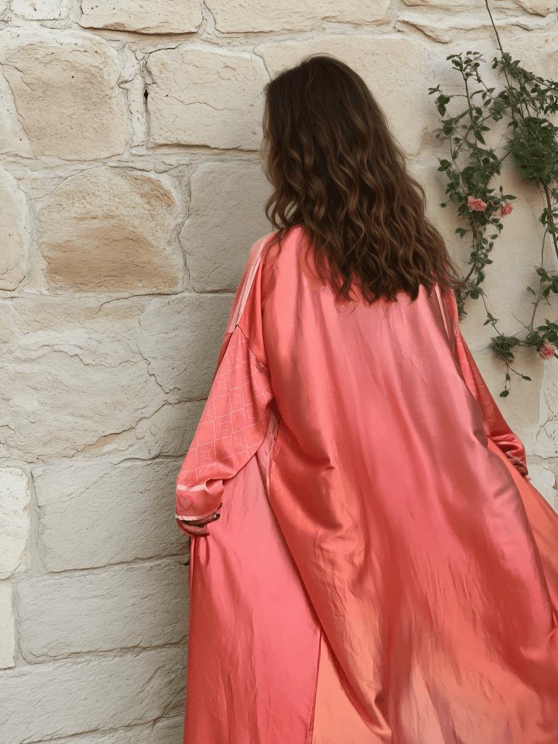 Back view of the Barbie-Inspired Pink Abaya Set highlighting its glossy fabric and relaxed silhouette, ideal for ceremonial occasions.