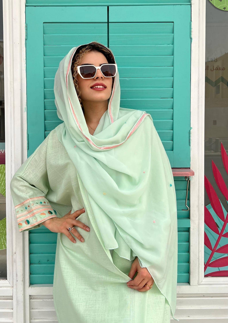 Model in cold mint Birthday Abaya & Scarf Set with pastel embroidery, styled for warm weather and cultural elegance.