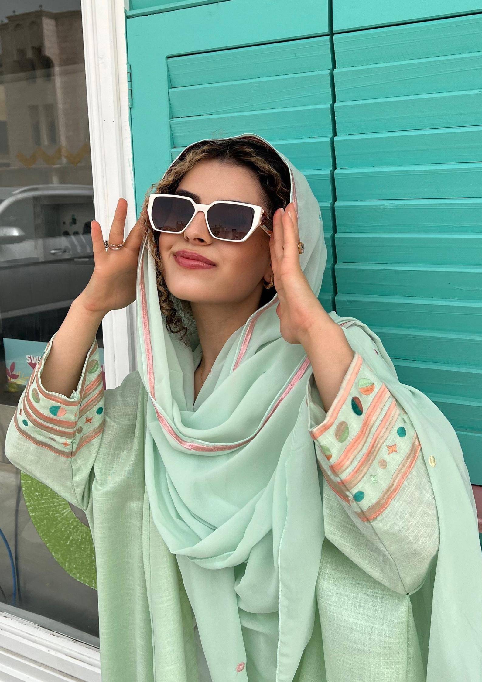 Model in Birthday Abaya & Scarf Set in cold mint, styled for summer with embroidered sleeves and flowing scarf.