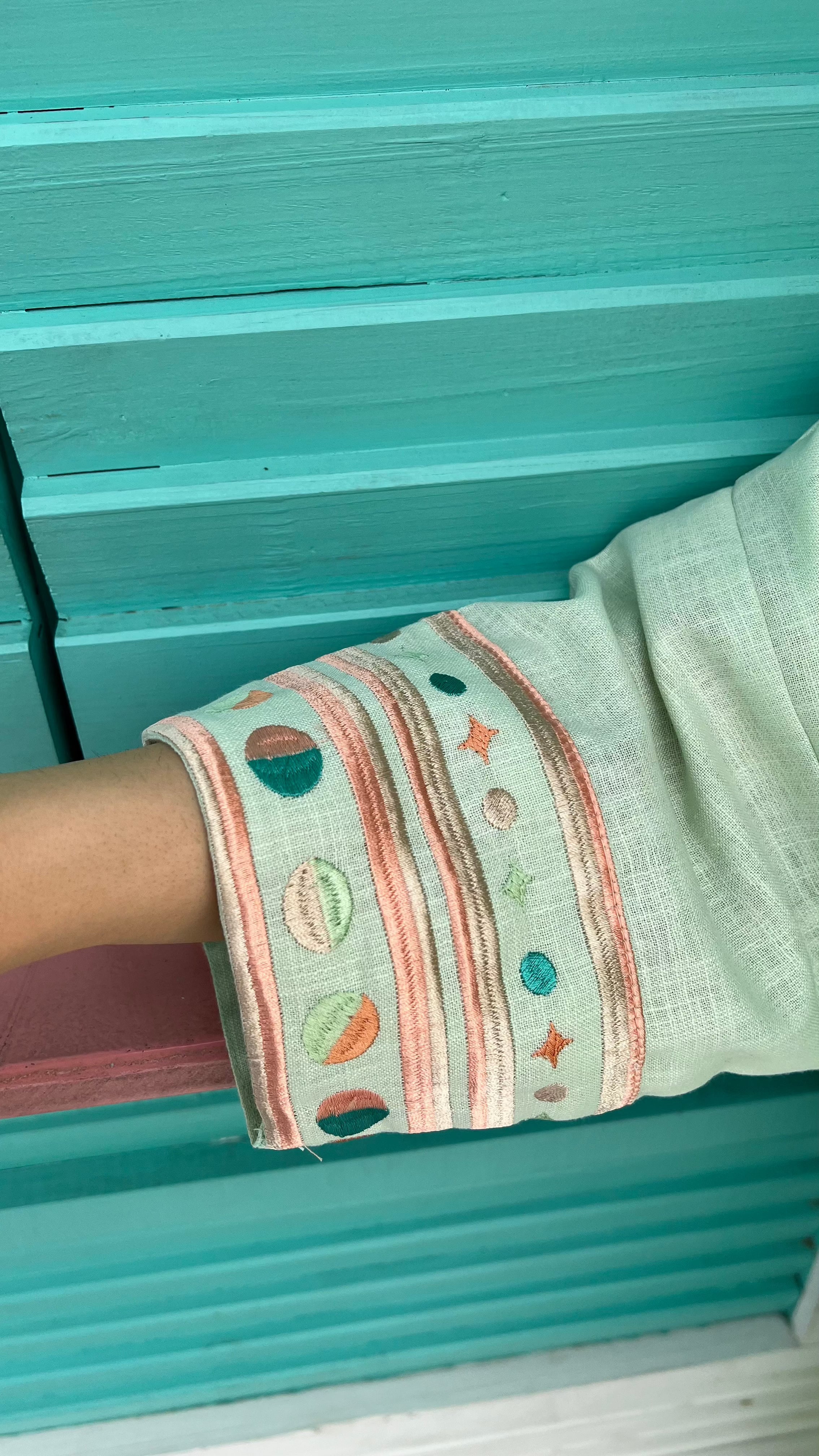 Detailed sleeve embroidery on cold mint Birthday Abaya, featuring pastel patterns perfect for summer ceremonial wear.