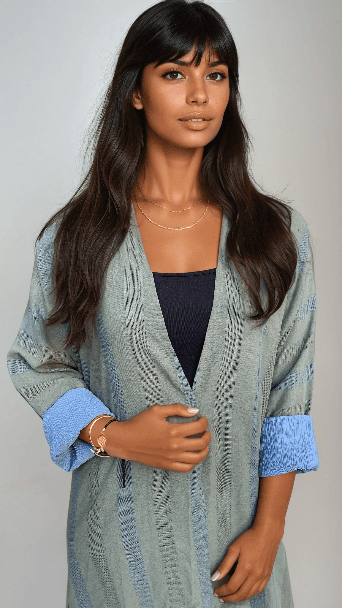 The WORKaholic Abaya - Daily Wear in sage green with blue cuffs, styled with black top and gold accessories.