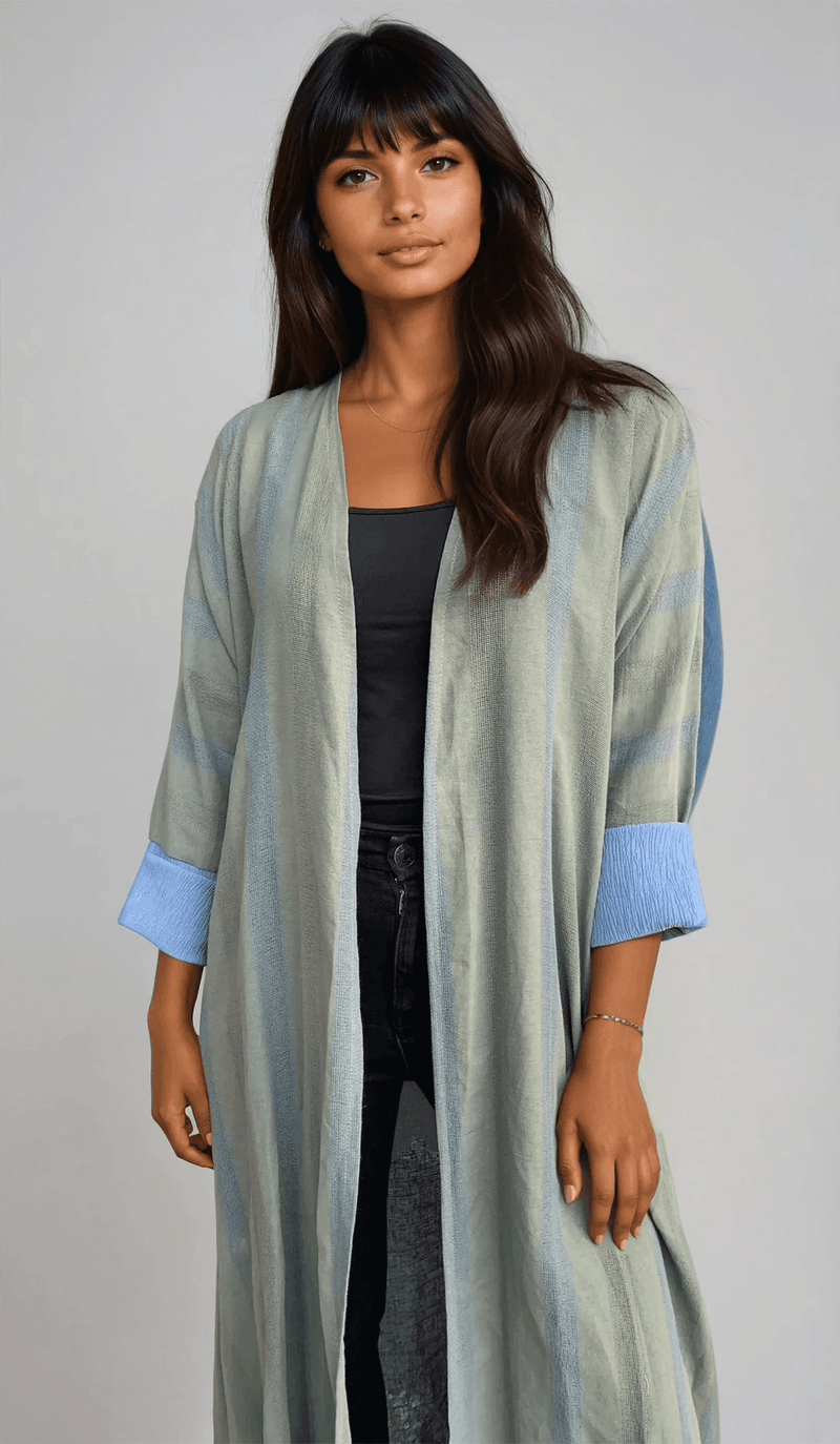 Front view of The WORKaholic Abaya - Daily Wear in green tones, styled open over a black outfit for a chic look.