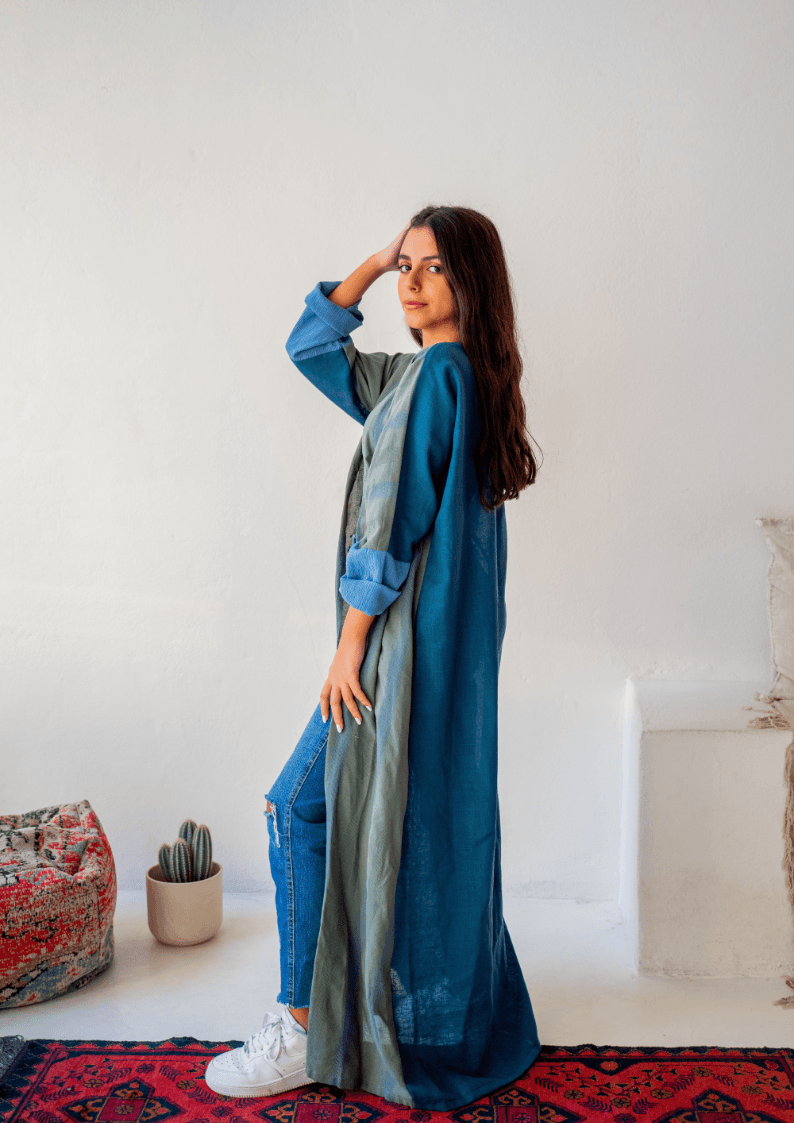 Side pose of The WORKaholic Abaya - Daily Wear in green, highlighting the contrast sleeve and relaxed fit.