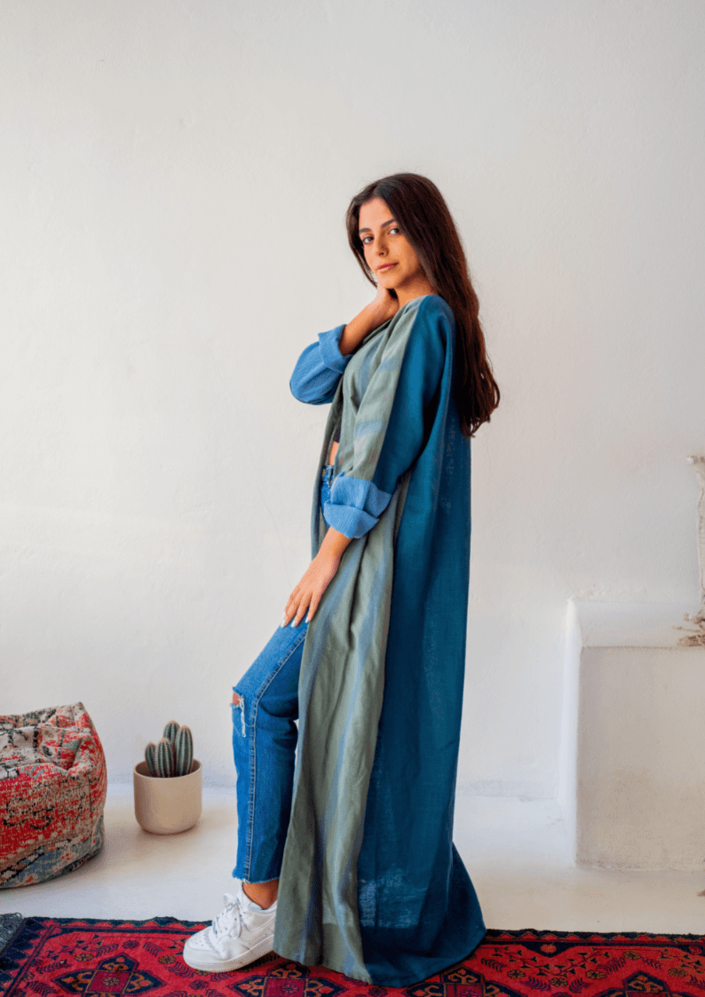 Angled view of The WORKaholic Abaya - Daily Wear in green, styled casually with rolled sleeves and denim.