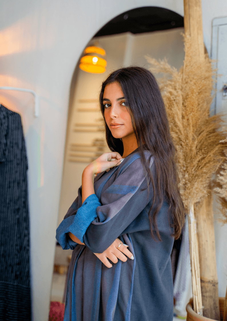 The WORKaholic Abaya - Daily Wear styled indoors, emphasizing the elegant drape and subtle striped detailing.