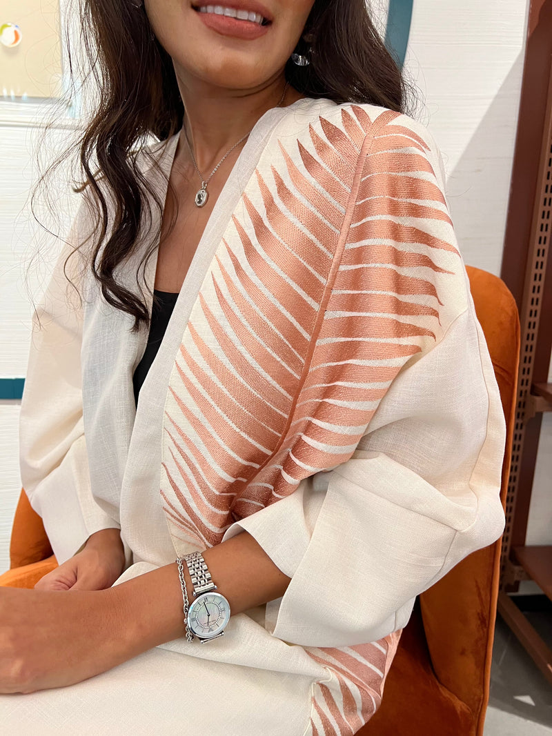 Rosé Gold Abaya - Breast Cancer Awareness | Solidarity, Hope. Close-up of rose gold abaya sleeve with intricate leaf embroidery, symbolizing hope.