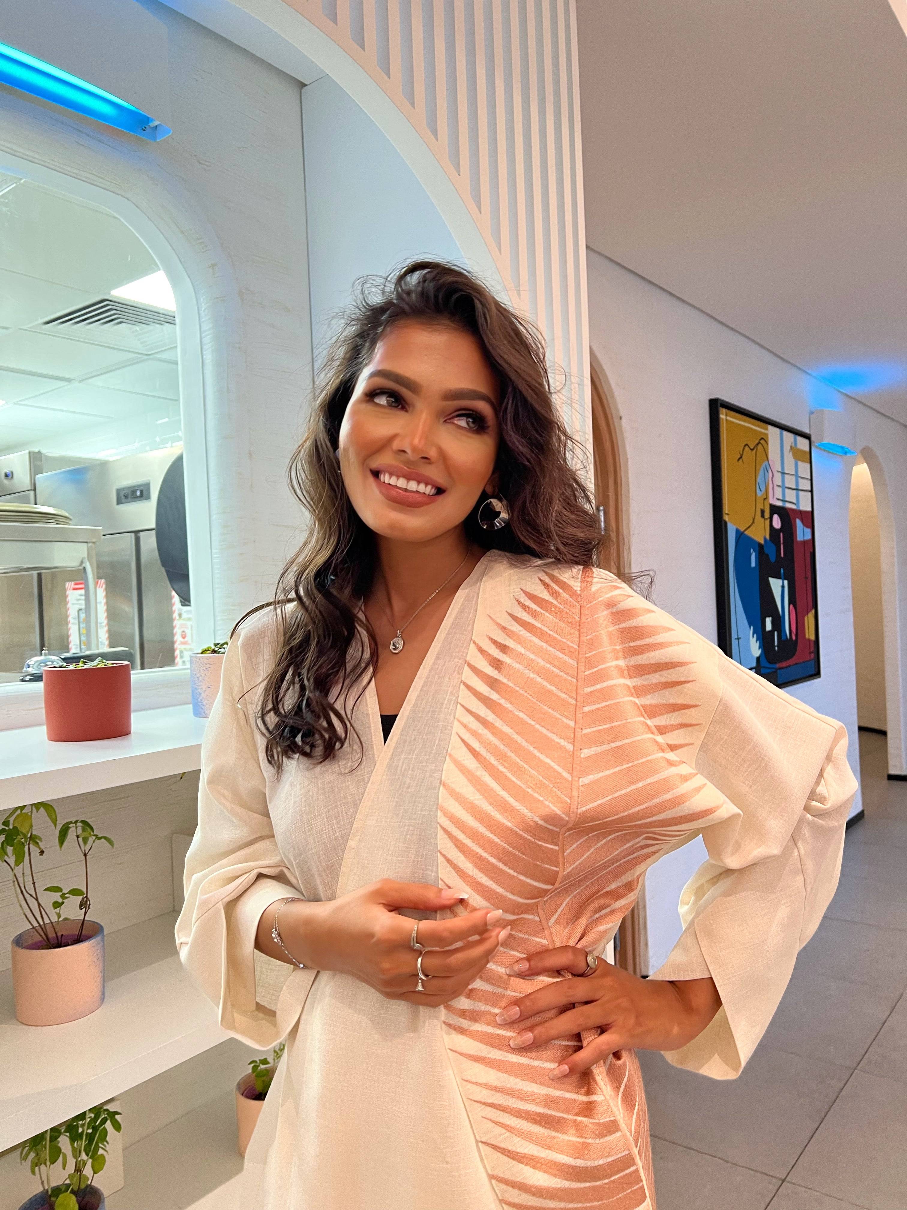 Rosé Gold Abaya - Breast Cancer Awareness | Solidarity, Hope. Confident pose in rose gold abaya, perfect for raising awareness through modest fashion.