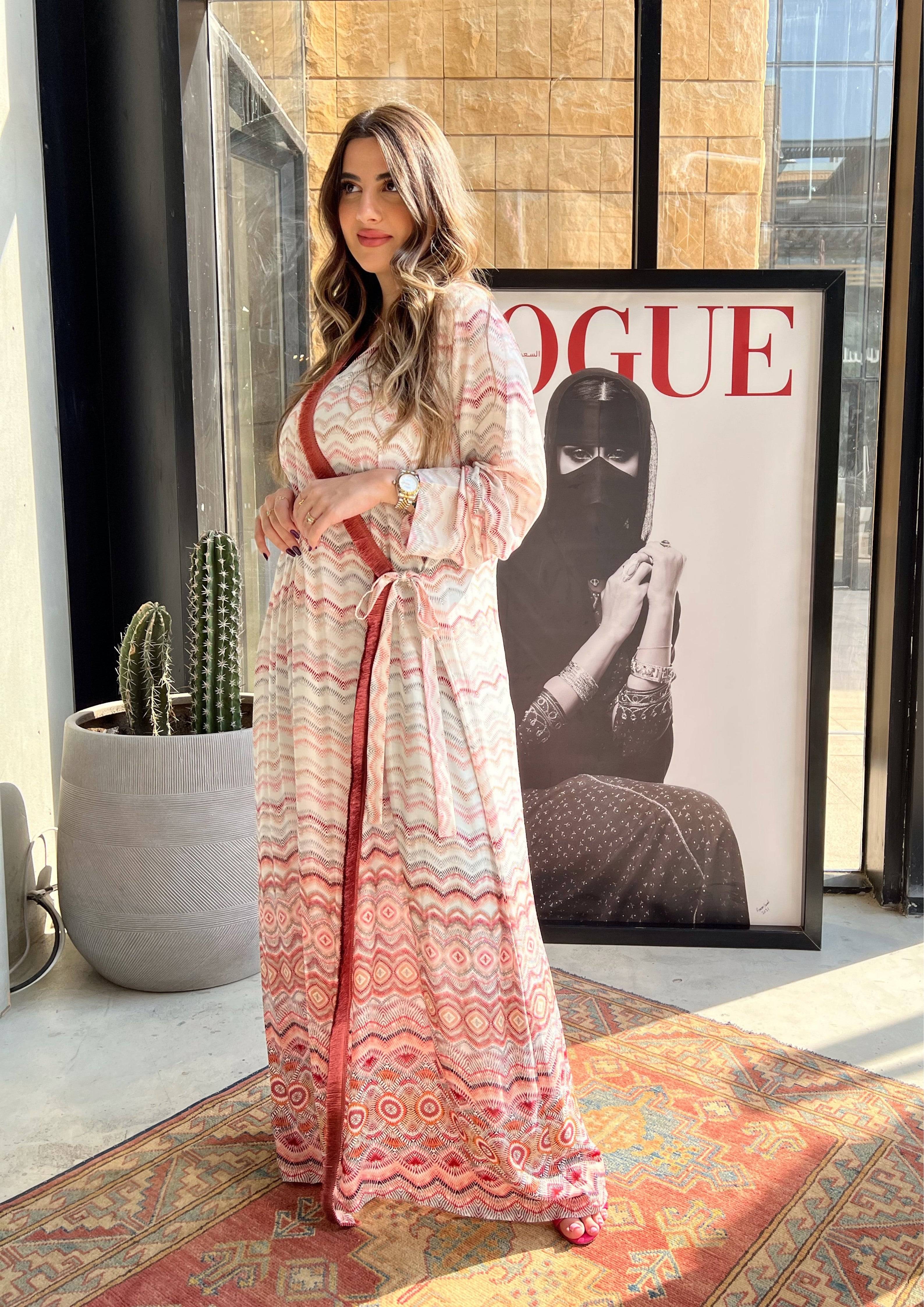 Full-body view of pink print abaya with red velvet wrap tie. Lightweight Saudi kimono perfect for stylish modest wear.