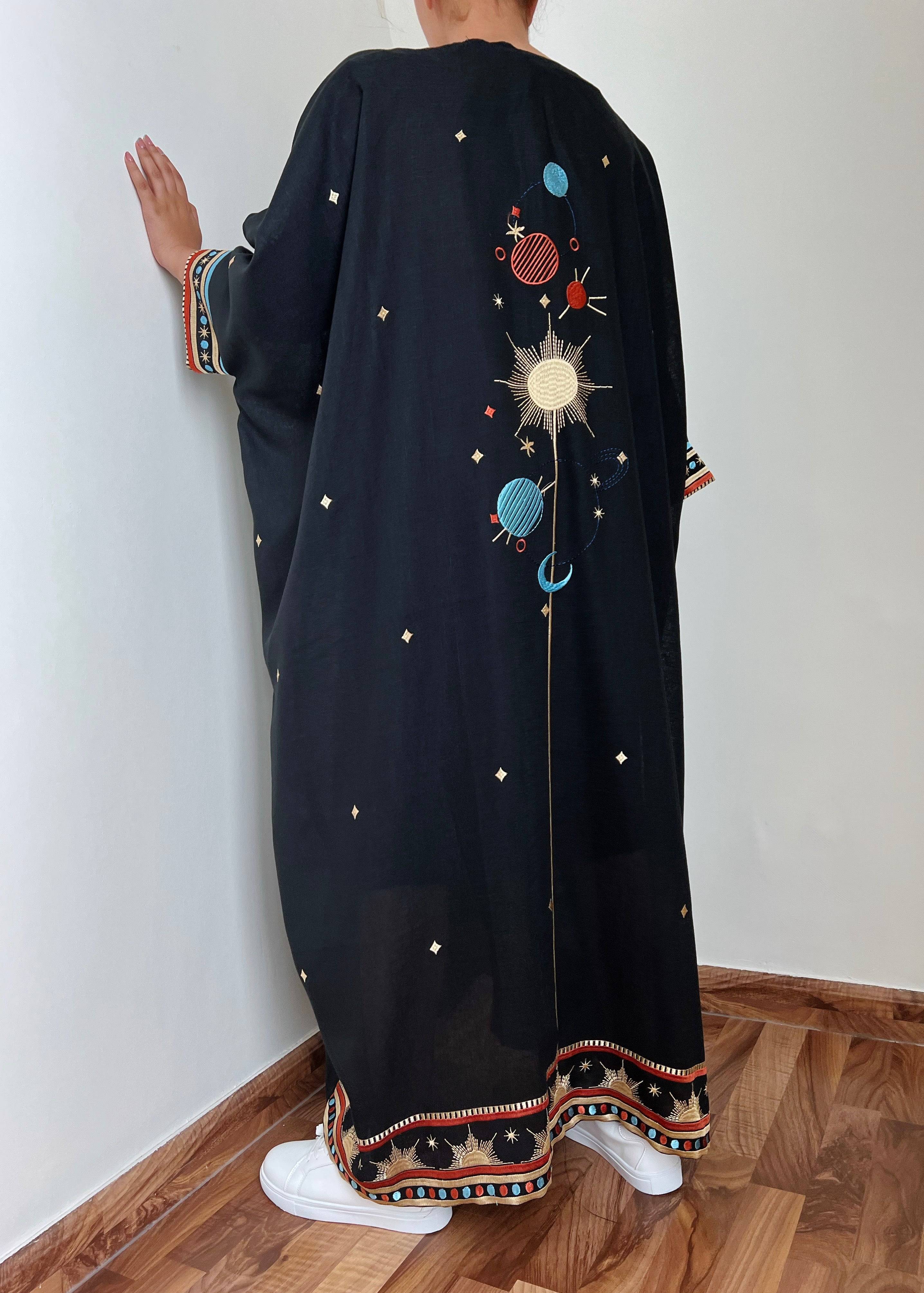 Back view of Distant Galaxies - Show Stopper Back Abaya with embroidered galaxy design and star accents, styled with sneakers for a modern twist.