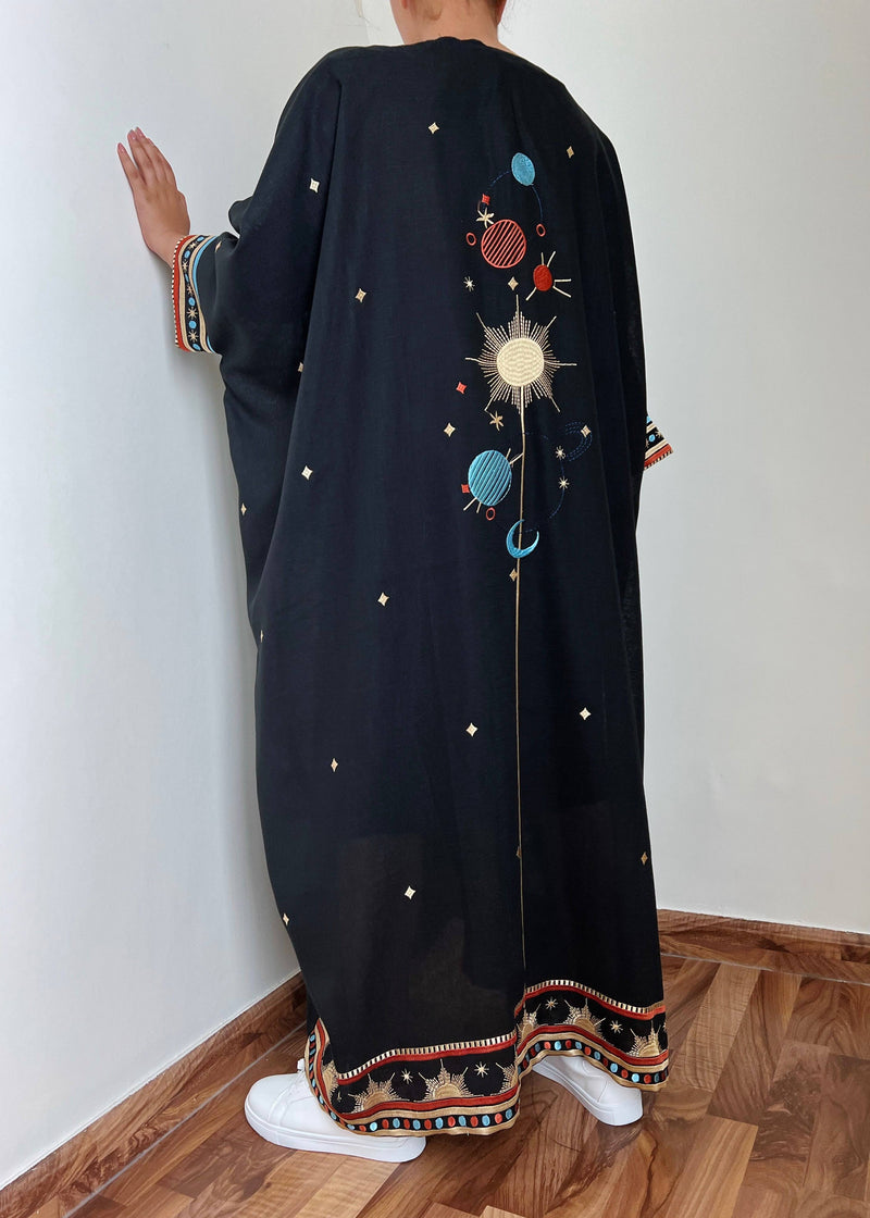 Back view of Distant Galaxies - Show Stopper Back Abaya with embroidered galaxy design and star accents, styled with sneakers for a modern twist.