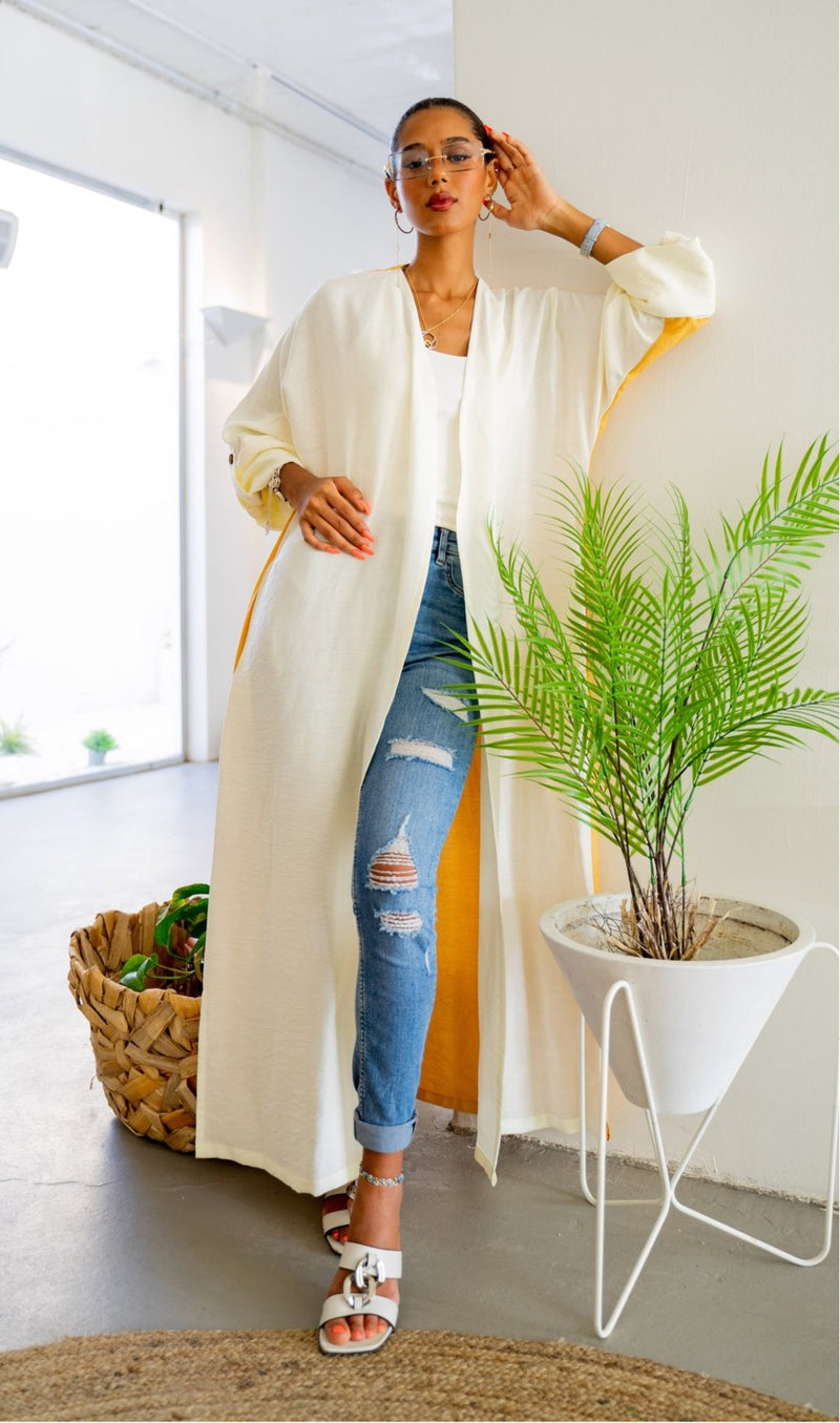 Full-length view of The Vicki Abaya - Daily Wear in mustard and white, styled with ripped jeans and sandals for a breezy daily look.