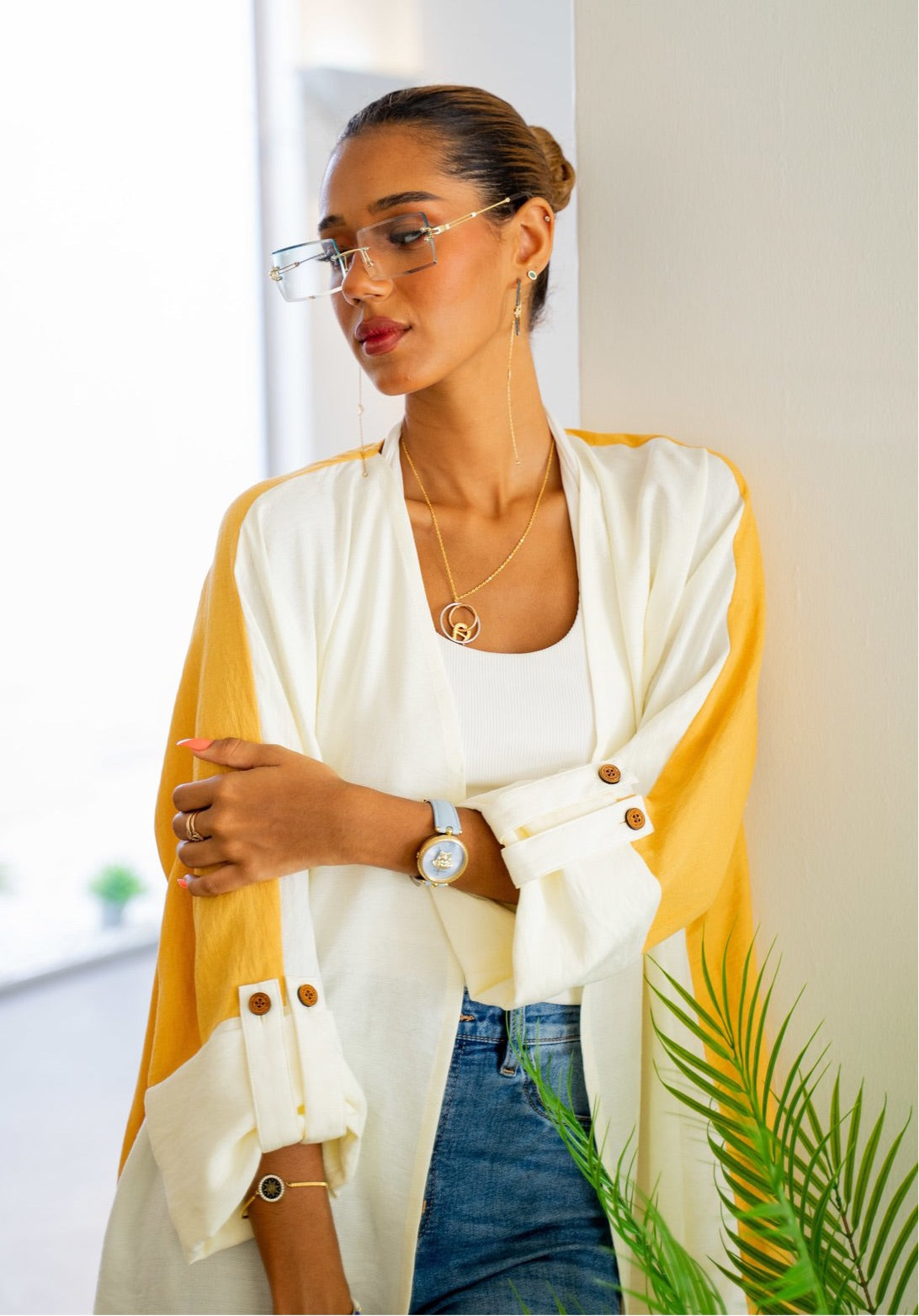 The Vicki Abaya - Daily Wear in white and mustard, styled with gold accessories and jeans for a modern, everyday fashion statement.