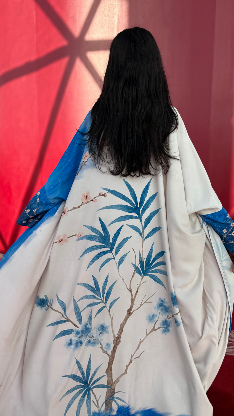 Art-inspired indigo silk abaya with hand-drawn botanical print — resortwear by The Untitled Project, perfect for Dubai or Jeddah summers.