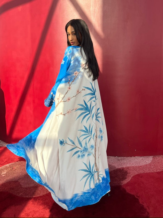 Model wearing blue and white printed abaya – She Thought in Indigo by The Untitled Project, sustainable fashion designed in Saudi Arabia.
