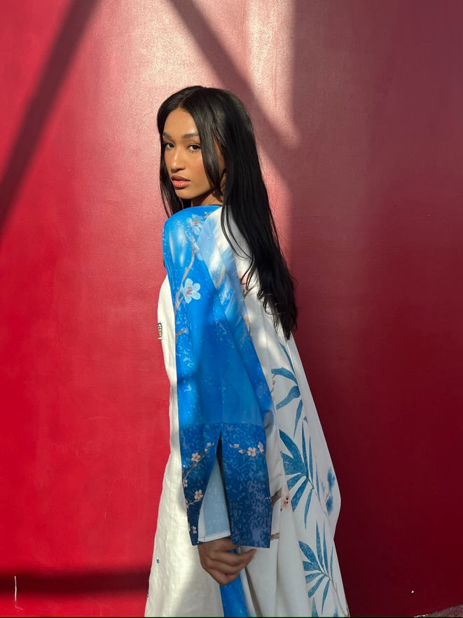 Luxury indigo abaya in eco-blend matte silk — The Untitled Project’s signature resortwear piece with botanical blue print.