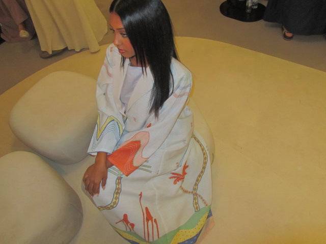 Close-up of The Jeddah Horizon - Abaya & Scarf Set’s lower half, highlighting palm tree and abstract desert motifs.