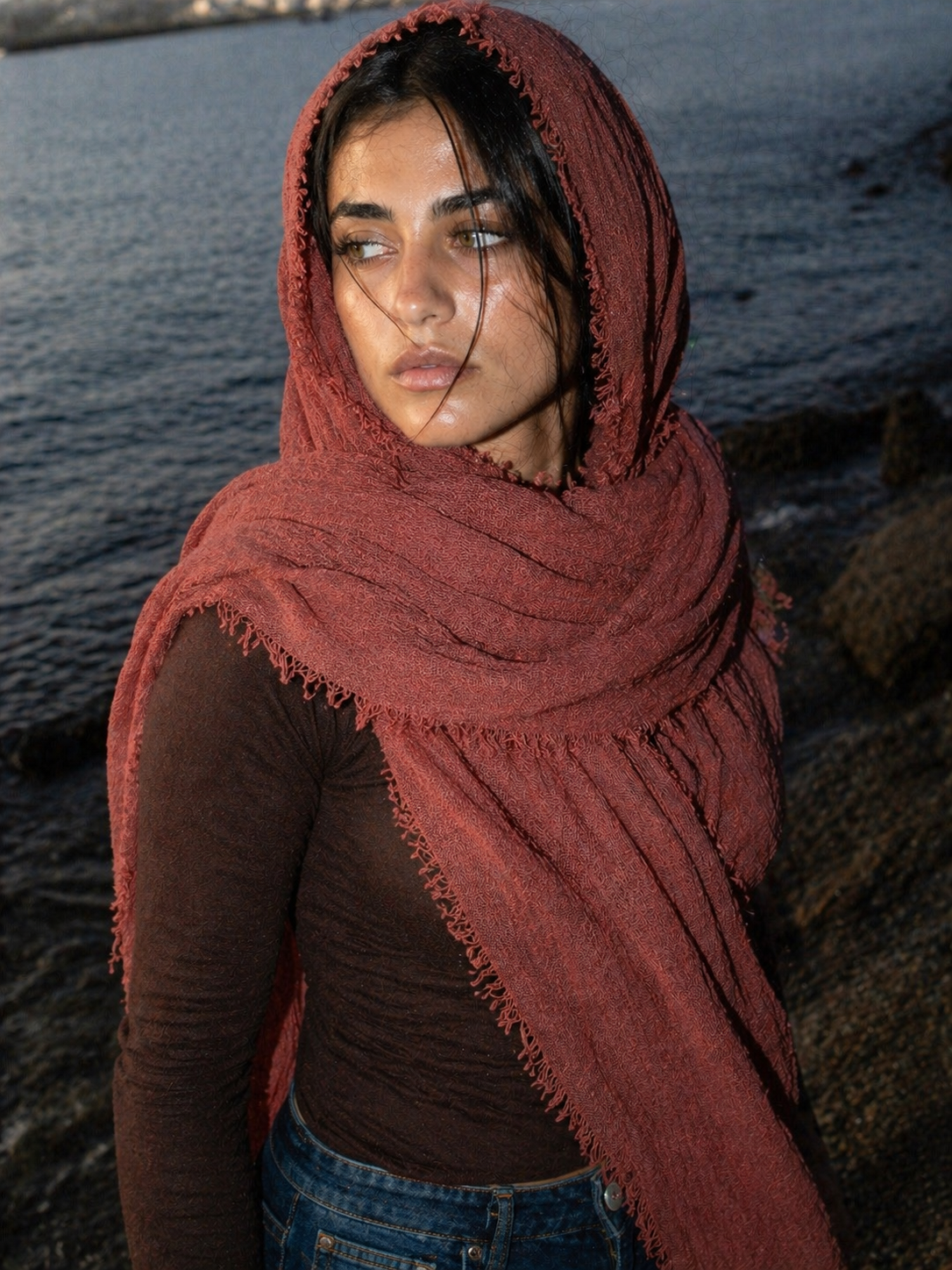 Woman wearing a red scarf with a blurred natural background