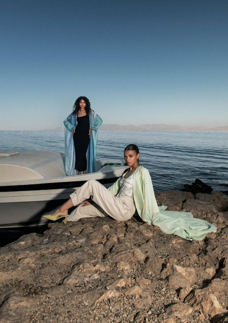 Indigo Dream Ombré Abaya Set styled with neutral tones by the sea, offering a modern twist on traditional wear for effortless summer sophistication.