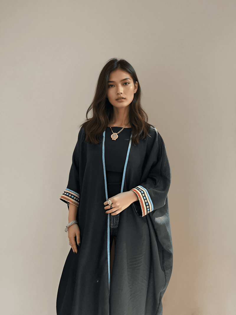 Model wearing Distant Galaxies - Show Stopper Back Abaya with minimal front design and embroidered cuffs, styled for elegant modest wear.