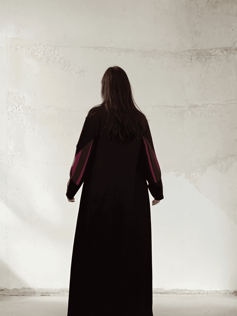 Back full-length view of The Front Row Feeling - Long Blazer, featuring bold magenta sleeve inserts on a minimalist black coat.