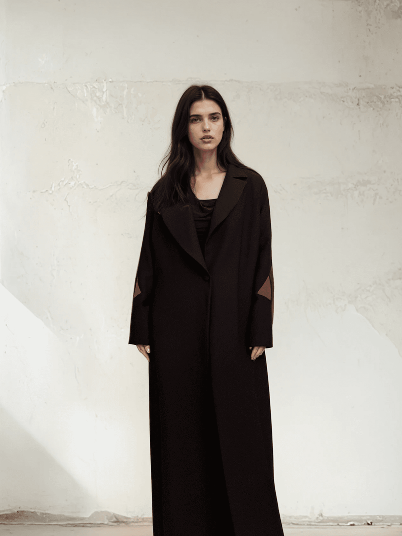 Full-length view of The Front Row Feeling - Long Blazer, featuring a sleek black design with subtle sleeve detailing, ideal for modern outerwear.