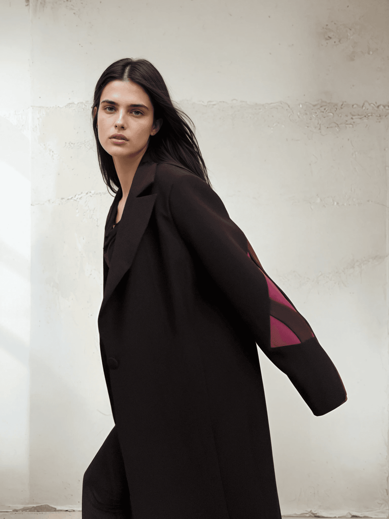 Dynamic pose in The Front Row Feeling - Long Blazer, emphasizing the structured shoulders and vibrant magenta sleeve design.