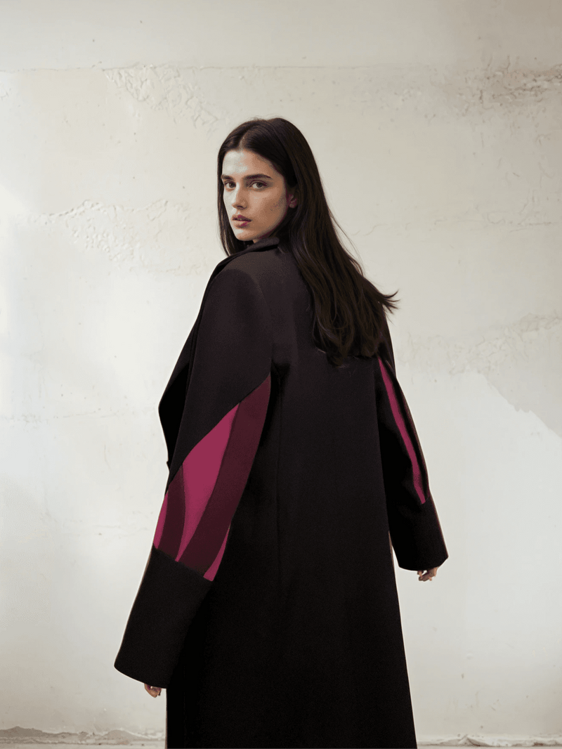 Rear angle of The Front Row Feeling - Long Blazer displaying the striking magenta sleeve accents on a flowing black silhouette.