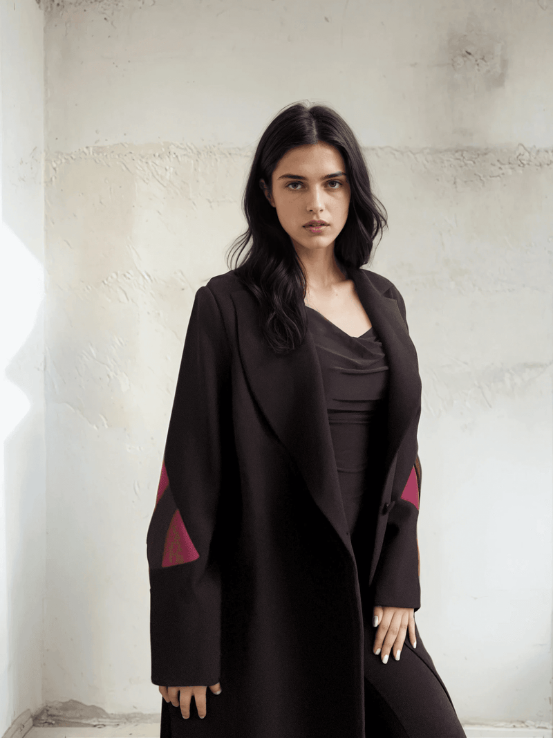 Close-up of The Front Row Feeling - Long Blazer showcasing luxe crepe fabric and sharp tailoring with magenta geometric sleeve inserts.