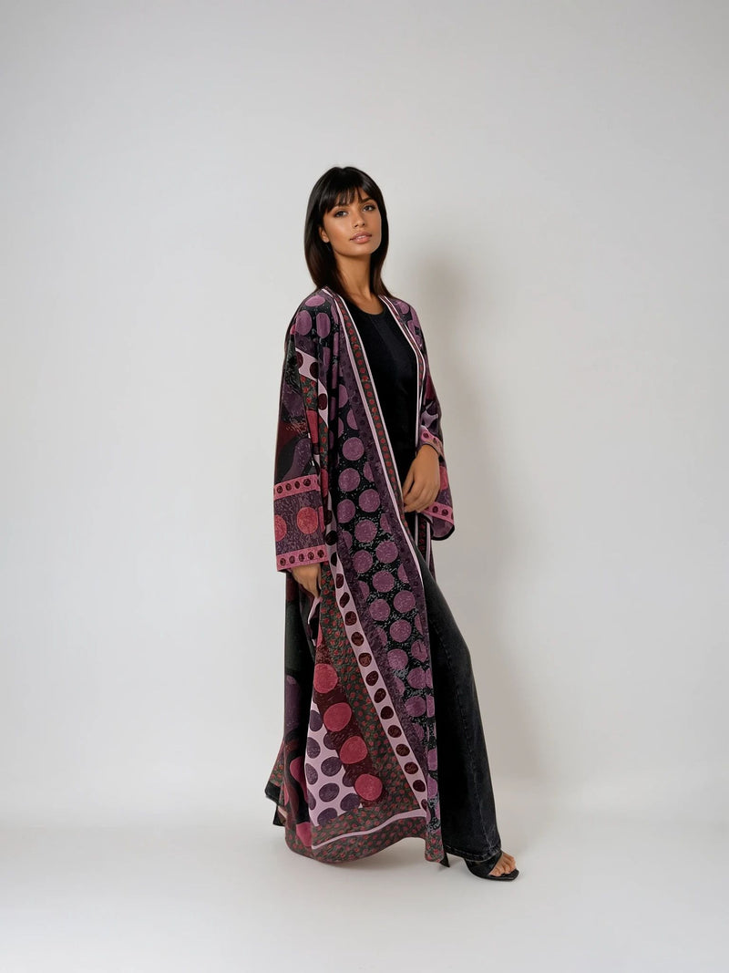 Model wearing The Untitled Project’s A Polka Thought abaya — printed matte silk design with playful purple polka dots.
