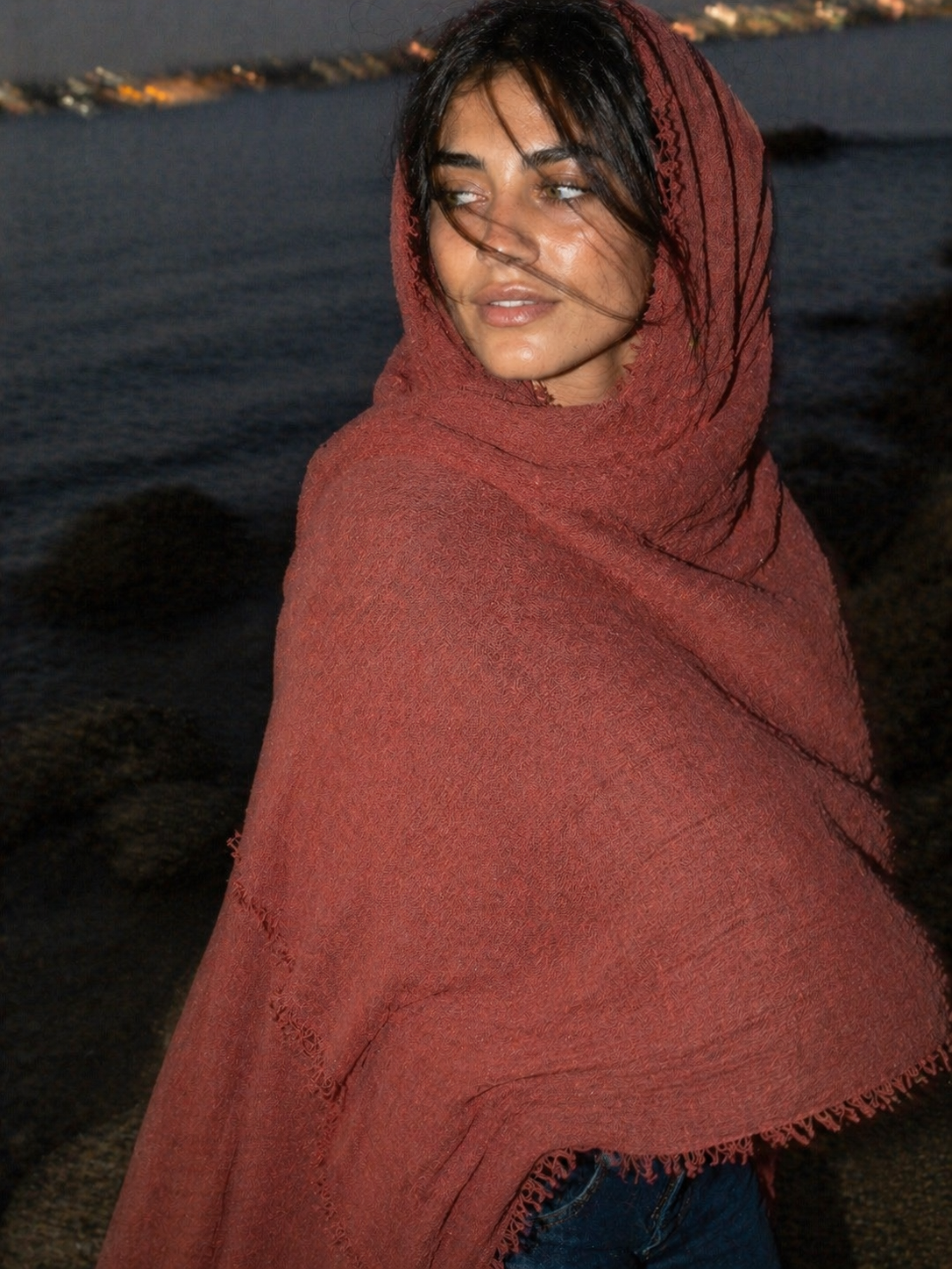 Person wearing a red scarf with a blurred background