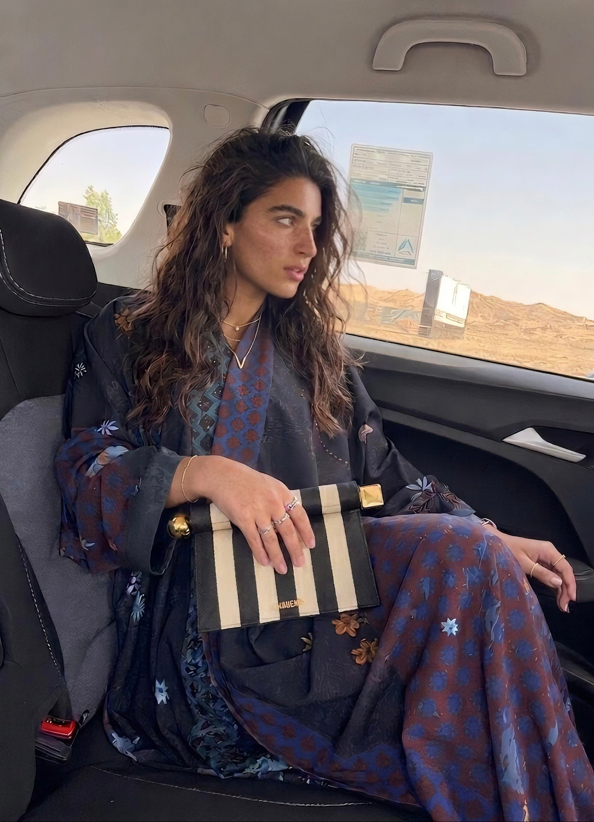 Corniche in Black, in the back seat of the car