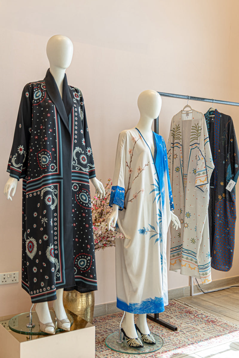 Mannequins wearing patterned dresses in a store setting